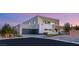 Modern two-story home with a flat roof, a three-car garage, and tasteful landscaping at 7385 Heron Canyon Ct, Las Vegas, NV 89117