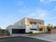 Contemporary two-story home featuring stucco exterior, flat roof, attached two car garage, and desert landscaping at 7385 Heron Canyon Ct, Las Vegas, NV 89117