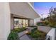 Inviting front entrance with a modern walkway, lush greenery, and a glimpse of the interior at 7385 Heron Canyon Ct, Las Vegas, NV 89117