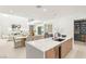 Bright open-concept kitchen featuring a large island, modern appliances, dining area, and seamless flow into the living space at 7385 Heron Canyon Ct, Las Vegas, NV 89117