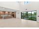 Open living space showcasing large windows, a modern kitchen, and abundant natural light at 7385 Heron Canyon Ct, Las Vegas, NV 89117