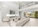 Elegant living room boasting a fireplace, high ceilings and large sofa for comfortable entertaining and relaxation at 7385 Heron Canyon Ct, Las Vegas, NV 89117