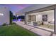 Modern living room featuring a modular sofa, large sliding glass doors, and serene backyard views with a sparkling pool at 7385 Heron Canyon Ct, Las Vegas, NV 89117
