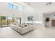 Expansive living room with high ceilings, large windows, and stylish furnishings create a bright and airy atmosphere at 7385 Heron Canyon Ct, Las Vegas, NV 89117