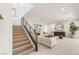 Open-concept living room featuring a staircase and modern decor at 7385 Heron Canyon Ct, Las Vegas, NV 89117
