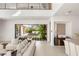 Modern living room with seamless indoor-outdoor flow, stylish furniture, and view to the landscaped backyard at 7385 Heron Canyon Ct, Las Vegas, NV 89117