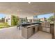 This expansive outdoor kitchen features stainless steel appliances and ample counter space for ultimate outdoor entertaining at 7385 Heron Canyon Ct, Las Vegas, NV 89117
