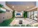 Beautiful outdoor patio with a modern fire pit, comfortable seating, and access to the home's interior at 7385 Heron Canyon Ct, Las Vegas, NV 89117