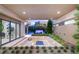 Serene outdoor patio with a sunken seating area, a fire pit, and seamless indoor-outdoor flow at 7385 Heron Canyon Ct, Las Vegas, NV 89117