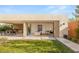 Seamless indoor-outdoor living with an outdoor kitchen, dining area, and lush lawn, perfect for entertaining at 7385 Heron Canyon Ct, Las Vegas, NV 89117