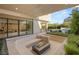 Outdoor lounge area featuring a sunken living area, a modern fire pit, and manicured landscaping at 7385 Heron Canyon Ct, Las Vegas, NV 89117