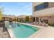 Relax by the sparkling pool with sun loungers, complemented by a lush green lawn and outdoor seating area at 7385 Heron Canyon Ct, Las Vegas, NV 89117