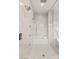 Luxurious shower with rainfall showerhead, bench, and marble tiling at 7385 Heron Canyon Ct, Las Vegas, NV 89117