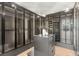Spacious walk-in closet with custom shelving and glass doors at 7385 Heron Canyon Ct, Las Vegas, NV 89117