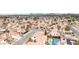 Overhead shot of a suburban neighborhood featuring terra cotta tile roofs, palm trees, and city views at 7445 Shangri La Ave, Las Vegas, NV 89147