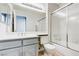Clean bathroom with a dual sink vanity, framed mirror, and a glass-enclosed tub-shower combo at 7445 Shangri La Ave, Las Vegas, NV 89147