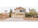 Two-story home features a two-car garage, well-maintained landscaping, and desert surroundings at 7445 Shangri La Ave, Las Vegas, NV 89147