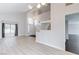 Bright living room with high ceilings, a staircase, and modern flooring at 7445 Shangri La Ave, Las Vegas, NV 89147