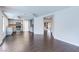 Open-concept living space featuring hardwood floors and an adjacent kitchen, perfect for modern living at 7445 Shangri La Ave, Las Vegas, NV 89147