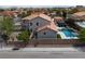Aerial view of home featuring a backyard oasis with pool, spa, and lush landscaping in a desirable neighborhood at 7569 Shadow Estates Way, Las Vegas, NV 89113