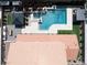 Backyard oasis with a sparkling blue swimming pool, manicured landscaping, and a covered patio at 7569 Shadow Estates Way, Las Vegas, NV 89113