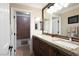 Bathroom with double sinks, granite countertops, and modern fixtures at 7569 Shadow Estates Way, Las Vegas, NV 89113