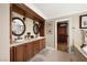 Bathroom featuring double vanities, a soaking tub, and a separate closet at 7569 Shadow Estates Way, Las Vegas, NV 89113
