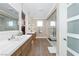 Luxurious bathroom with double sinks, a walk-in shower, and access to a modern walk-in closet at 7569 Shadow Estates Way, Las Vegas, NV 89113