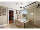 Bathroom features a glass-enclosed shower, soaking tub, and walk-in closet at 7569 Shadow Estates Way, Las Vegas, NV 89113