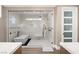 Elegant bathroom with a glass enclosed shower and tub featuring a modern design and stylish fixtures at 7569 Shadow Estates Way, Las Vegas, NV 89113