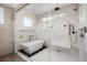 Modern bathroom with a glass enclosed shower and tub, featuring a sleek design and luxurious amenities at 7569 Shadow Estates Way, Las Vegas, NV 89113