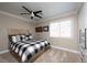 Comfortable bedroom with black and white accents and plush carpet at 7569 Shadow Estates Way, Las Vegas, NV 89113