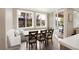 Bright breakfast nook with a built-in bench, a large table, and views of the backyard and swimming pool at 7569 Shadow Estates Way, Las Vegas, NV 89113