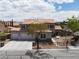 Inviting two-story home featuring a three-car garage and beautiful desert landscaping at 7569 Shadow Estates Way, Las Vegas, NV 89113