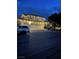 Spacious two-story home featuring a three-car garage and charming exterior lighting at 7569 Shadow Estates Way, Las Vegas, NV 89113