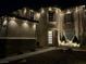 Elegant home with a welcoming entrance, decorative lighting, and well-maintained landscaping at 7569 Shadow Estates Way, Las Vegas, NV 89113