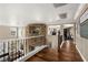 Hallway with stone detailing, wrought iron railing, and views of the living area at 7569 Shadow Estates Way, Las Vegas, NV 89113