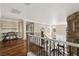 Hallway featuring hardwood floors, stone accents, and wrought iron railings at 7569 Shadow Estates Way, Las Vegas, NV 89113