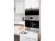 Built-in stainless steel oven and microwave with organized pantry drawers at 7569 Shadow Estates Way, Las Vegas, NV 89113