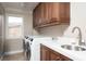 Well-equipped laundry room with washer, dryer, and ample counter space at 7569 Shadow Estates Way, Las Vegas, NV 89113