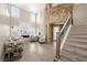 Bright, open living room with a stone fireplace, high ceilings, and large windows at 7569 Shadow Estates Way, Las Vegas, NV 89113