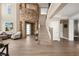 Stunning great room with soaring stone wall, staircase, and hardwood flooring at 7569 Shadow Estates Way, Las Vegas, NV 89113