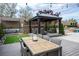 Outdoor dining and entertaining area with gazebo and string lights at 7569 Shadow Estates Way, Las Vegas, NV 89113
