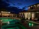 Backyard pool area with a covered lounge, patio, and beautiful outdoor lighting at 7569 Shadow Estates Way, Las Vegas, NV 89113