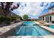 Inviting swimming pool with water feature, landscaping, and backyard at 7569 Shadow Estates Way, Las Vegas, NV 89113