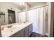 Bathroom featuring a double sink vanity, white shower curtain, and neutral wall color at 7704 Himalayas Ave # 204, Las Vegas, NV 89128