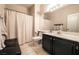 Bathroom with dark wood vanity, white tile flooring, and shower/tub combo at 7704 Himalayas Ave # 204, Las Vegas, NV 89128