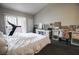 Comfortable bedroom with a sliding door to balcony, desk with chair, and a chest of drawers at 7704 Himalayas Ave # 204, Las Vegas, NV 89128