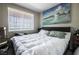Relaxing bedroom with a large bed, window, and a serene painting adorning the wall at 7704 Himalayas Ave # 204, Las Vegas, NV 89128