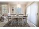 Cozy dining area with a chandelier, adjacent to the living room, perfect for entertaining at 7704 Himalayas Ave # 204, Las Vegas, NV 89128